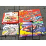 Four slot car racing sets by Scalextric and others to include The Scalextric Formula 1 set,