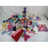 Barbie - A quantity of Barbie doll clothes and accessories to include brushes, suitcases, shoes,