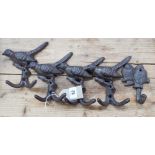 Five assorted cast iron bird shaped coat hooks