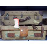 Four old canvas suitcases and one square canvas trunk