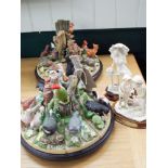 Revolving stand with birds of the forest by Danbury Mint and a similar woodland life stand together