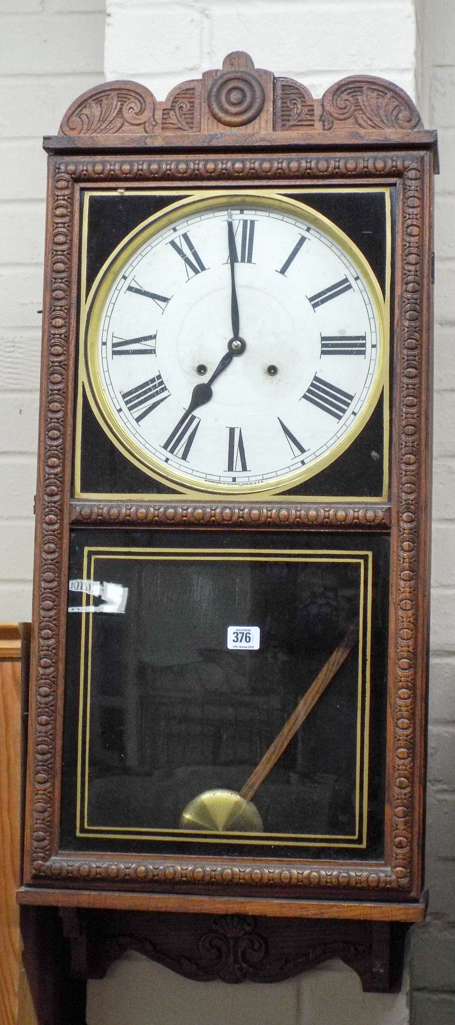 An American striking wall clock in oak and glazed case