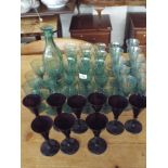 A quantity of assorted green wine glasses,