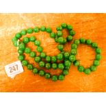 A long green jade bead necklace