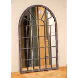 A small Gothic designed metal framed outdoor mirror