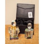 Two small glass perfume bottles one with box