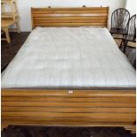 A 5' French style light oak finished sleigh bed