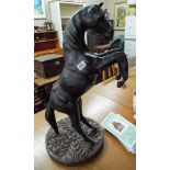 A leather rearing horse ornament on carved base approx 25" tall