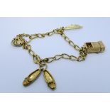 A modern 9ct yellow gold charm bracelet with a diamond set heart shaped padlock fastening,