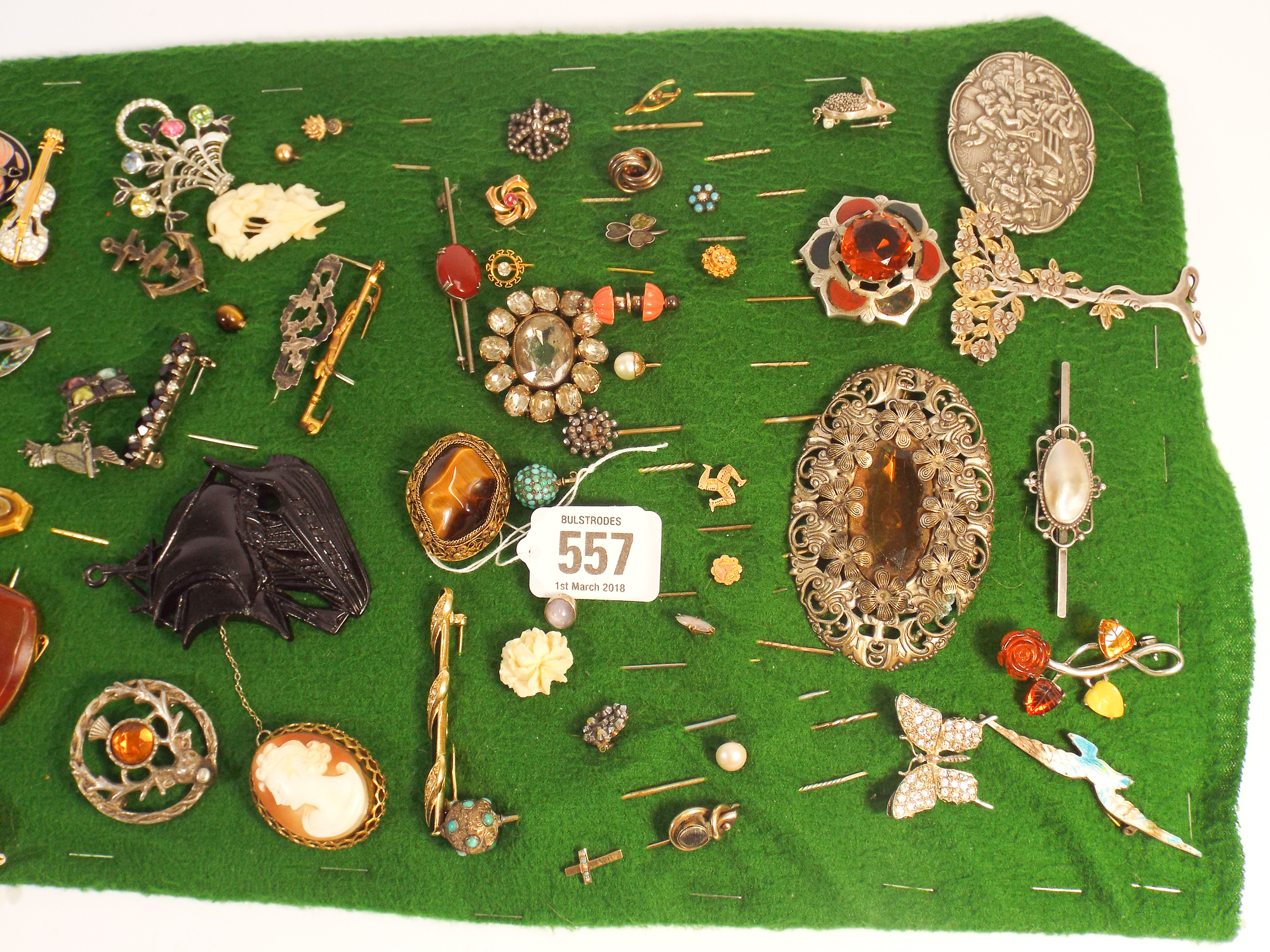 A collection of 19th century and later brooches and stick pins, some silver, some gold,