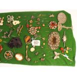 A collection of 19th century and later brooches and stick pins, some silver, some gold,