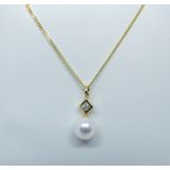A cultured pearl and diamond pendant set in 18ct yellow gold on a fine gold chain