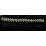 A 14ct yellow gold and diamond line bracelet gross 12.