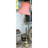 A brass corinthian column standard lamp standing on paw feet