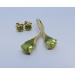 A 9ct yellow gold modern peridot set pendant and a pair of matching ear studs