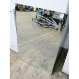 An etched unframed mirror