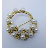A 14ct yellow gold and cultured pearl brooch modelled as a circular wreath with 14 cultured pearls