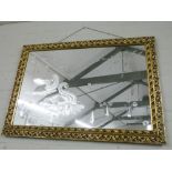 An etched mirror with gilt frame,