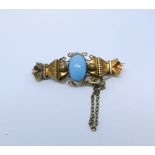 A Victorian 15ct yellow gold bar brooch set with an oval Turquoise stamped 15ct to reverse with pin