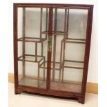 A glazed mahogany display cabinet with graduated shelves and glass doors 28" wide 36" high