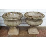 A pair of reconstituted stone urn shaped concrete platers