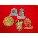 A collection of various fire marks and plaques