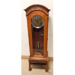 An early 20th century Invicta electric regulator clock in walnut case with glass door 52" high 15"