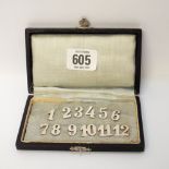 A cased set of twelve German silver peg markers