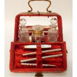 A 19th century ladies travelling etui, the red velvet case opening to reveal sewing implements,