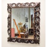 A large French cushion style wall mirror in decorative carved oak frame approx 3'6 x 3' overall