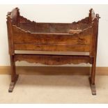 An antique oak rocking crib