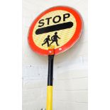 A Lollipop Lady 'Stop children crossing'