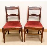 A set of four Georgian mahogany dining chairs with bar back and red upholstered seats