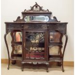 Edwardian dark mahogany shaped front display cabinet with side shelves and glazed centre door with