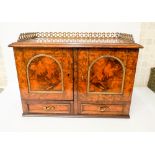 A small Victorian figured Walnut two door cabinet fitted with two draws with brass mounts and