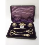 A seven piece manicure set contained within a plush purple case to include scent bottles, scissors,