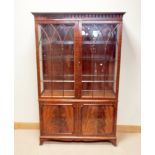 A good quality mahogany lattice glazed china display cabinet standing on a two door cupboard base