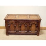 A reproduction oak blanket chest fitted three carved panel front 45" wide