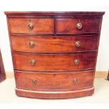 An early Victorian mahogany bow front chest of three long and two short drawers with brass ring