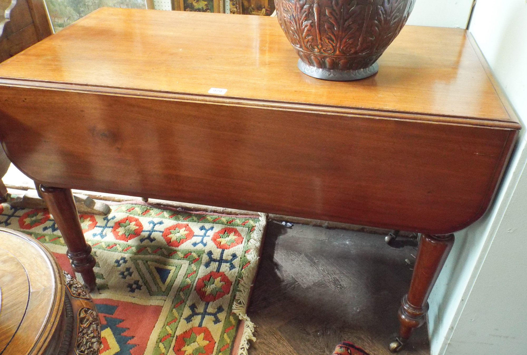 A Victorian mahogany Pembroke table fitted drawer standing on turned legs 3'6 wide