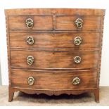 A Georgian mahogany bow front chest of three long and two short drawers with brass ring handles