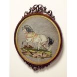 A small Victorian mahogany framed circular tapestry picture of a horse