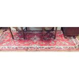 A red and patterned wool pile Persian designed carpet runner 116"x39"