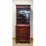 A Georgian mahogany lattice glazed bookcase standing on a dummy drawers cupboard base with interior