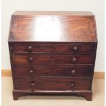 A Georgian mahogany bureau with four drawers under with Victorian bun handles fitted 3'3 wide