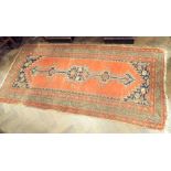 A red and patterned Persian rug 78"x37"