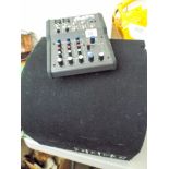 A large Edgi car sub-woofer and Alesis multi mix 4 music mixer