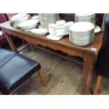 A large oak dining table, fitted with one drawer, on square legs.