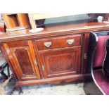 An Edwardian mahogany sideboard fitted cupboards and centre drawer with original brass handles,