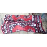 A Bokhara design red patterned wool pile carpet runner